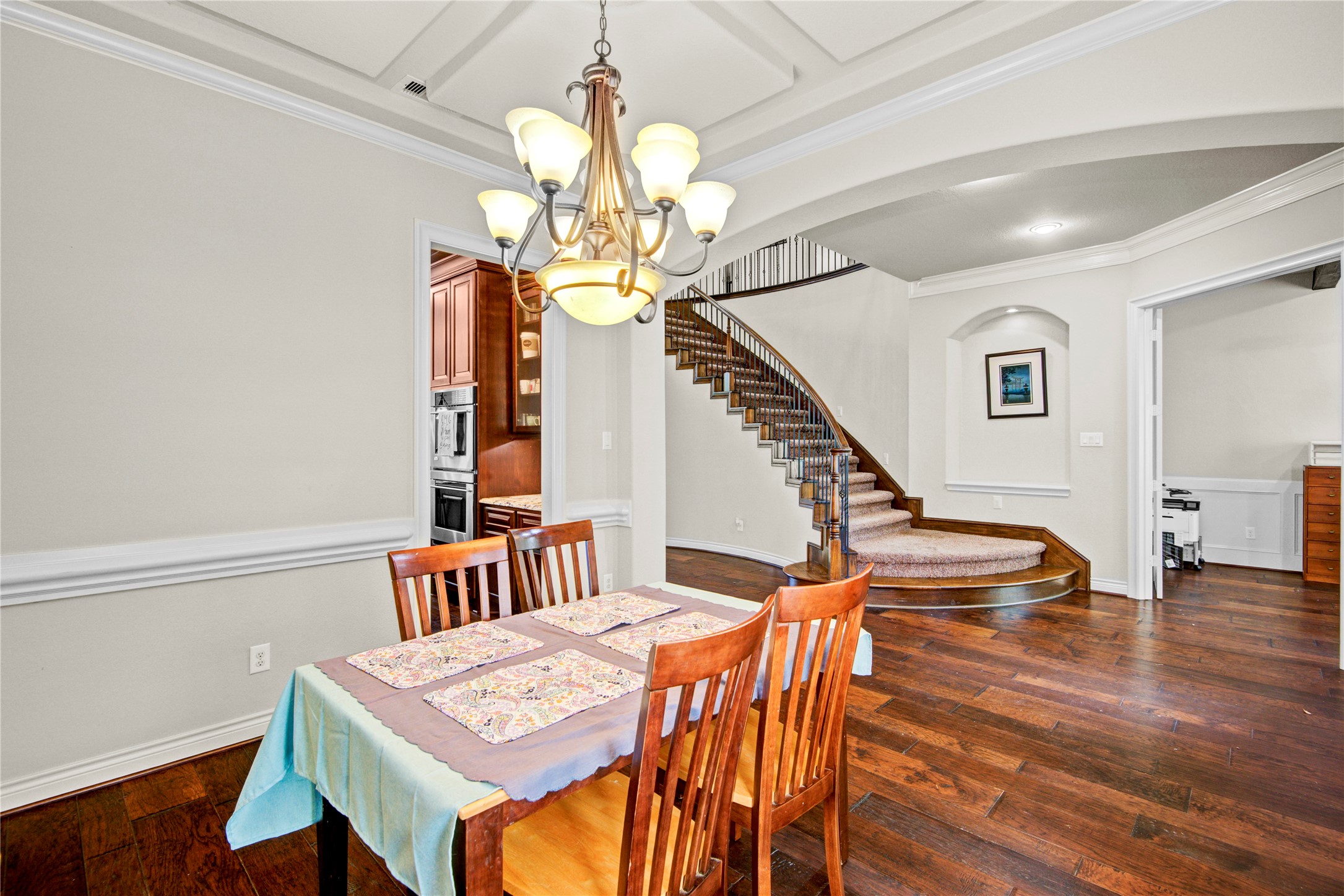 4315 Sanctuary Halls Spring, TX 77388 - Photo 43 of 50 a dining room with wooden floor a chandelier a wooden table and chairs