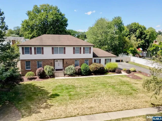 a view of a house with yard and sitting area
