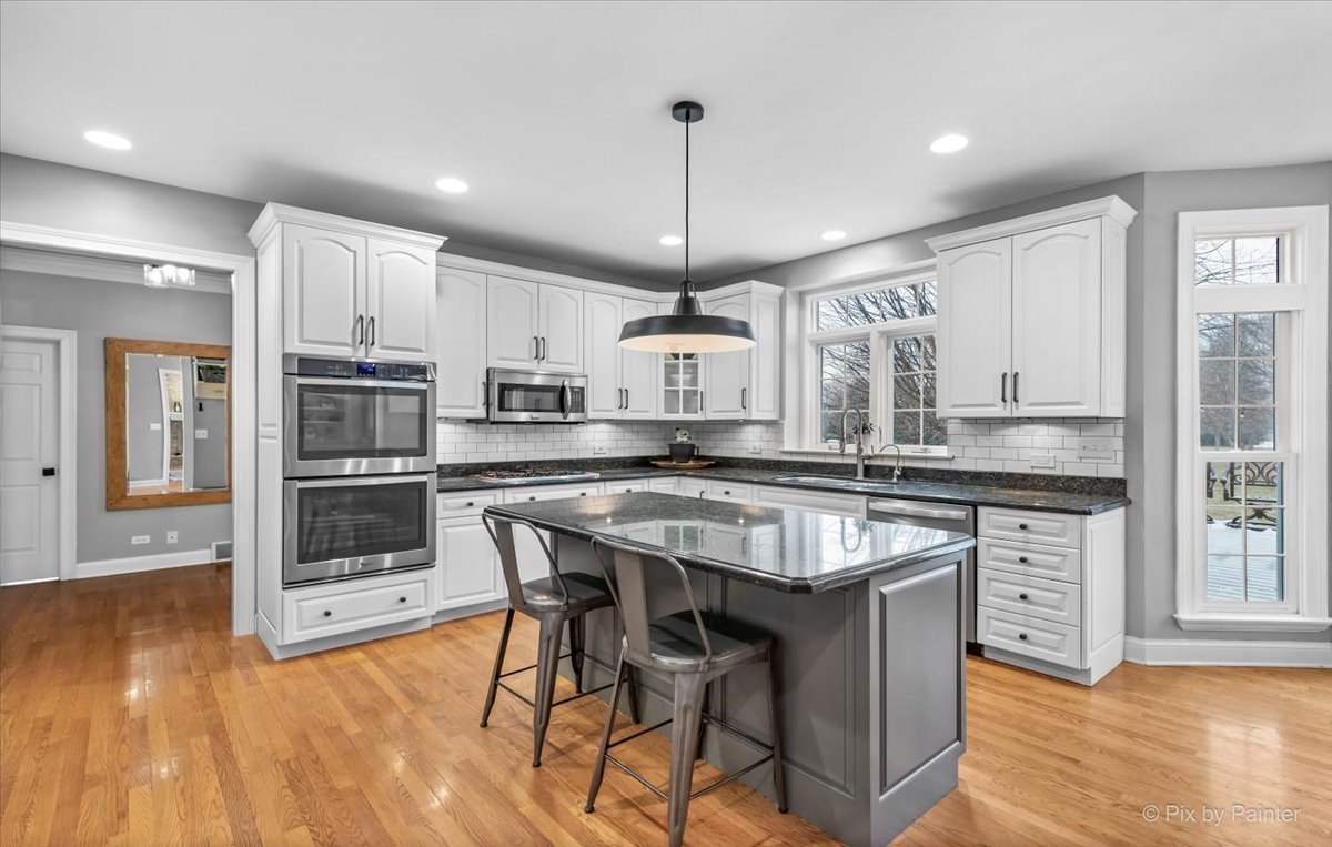 7N580 Wagontire Road St. Charles, IL 60175 - Photo 11 of 52 a kitchen with stainless steel appliances granite countertop a stove refrigerator and cabinets