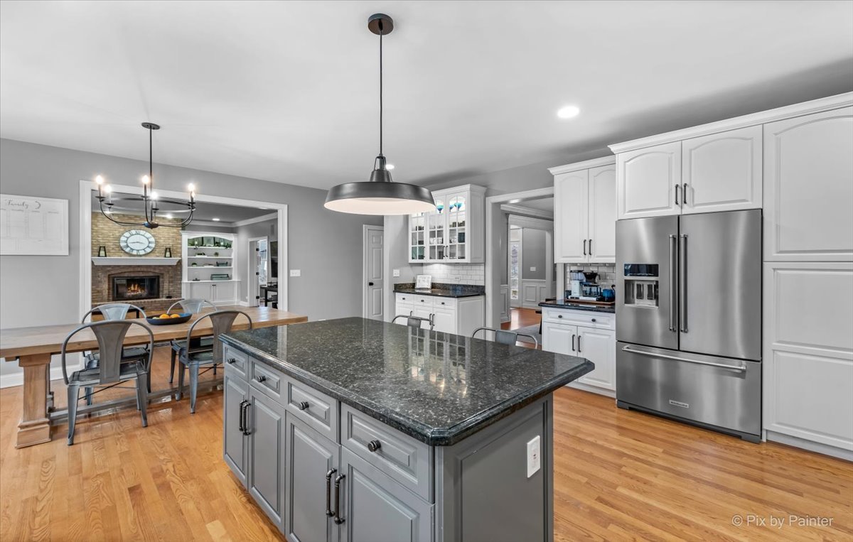 7N580 Wagontire Road St. Charles, IL 60175 - Photo 13 of 52 a kitchen with stainless steel appliances granite countertop a kitchen island a stove a refrigerator a kitchen island a dining table and chairs with wooden floor