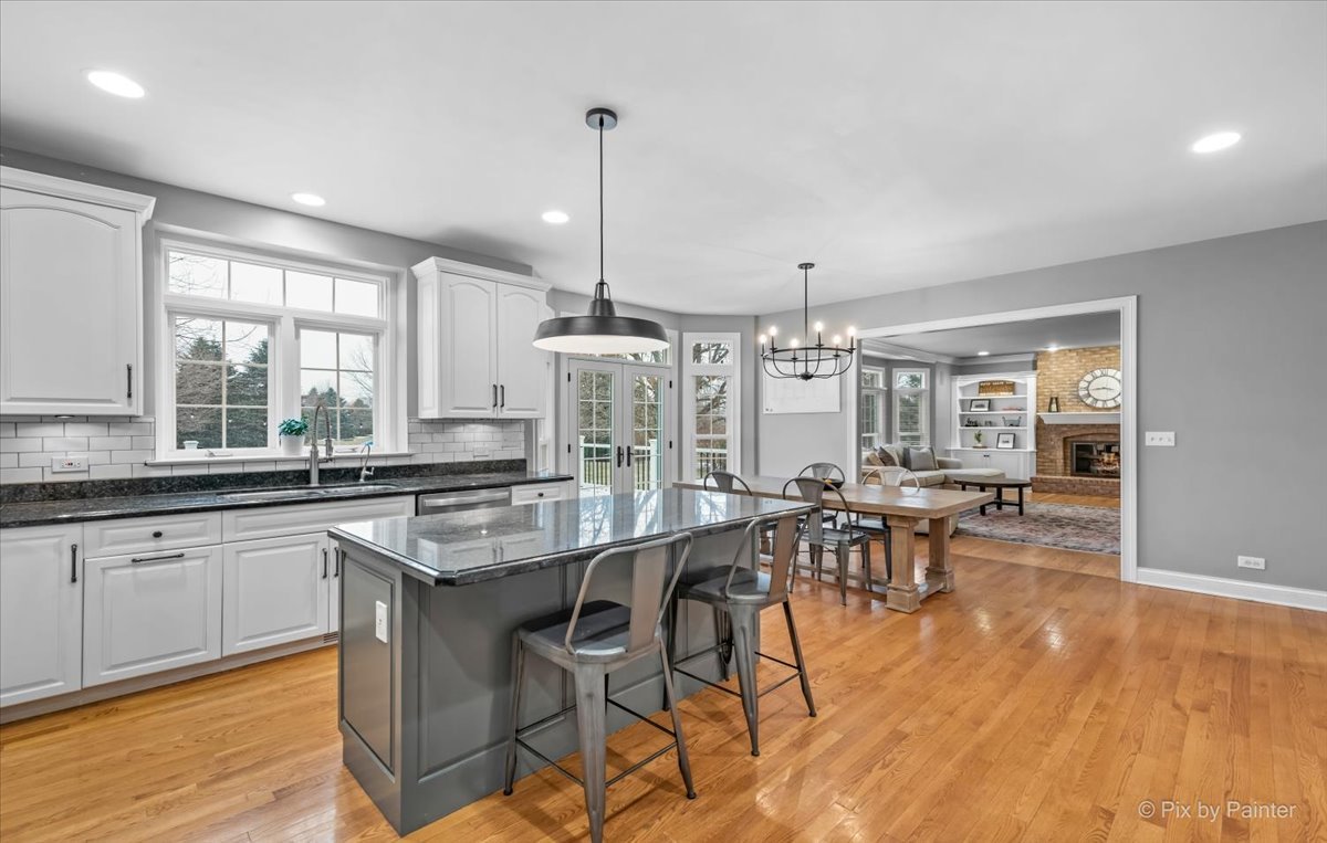 7N580 Wagontire Road St. Charles, IL 60175 - Photo 14 of 52 a kitchen with stainless steel appliances granite countertop a table chairs stove and wooden cabinets