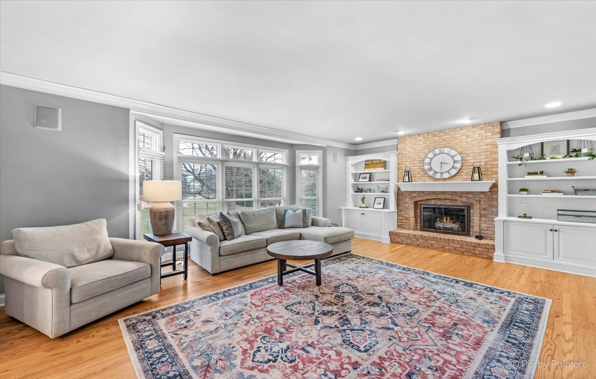 7N580 Wagontire Road St. Charles, IL 60175 - Photo 16 of 52 a living room with furniture a fireplace and a large window