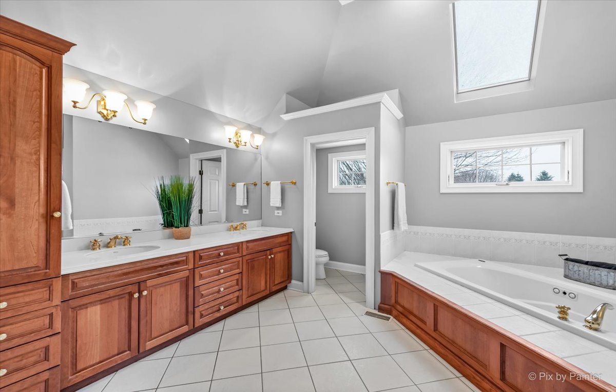 7N580 Wagontire Road St. Charles, IL 60175 - Photo 23 of 52 a spacious bathroom with a granite countertop sink mirror and bathtub