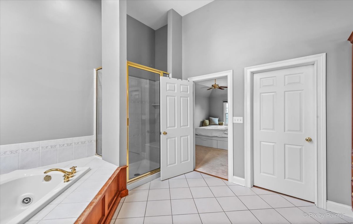 7N580 Wagontire Road St. Charles, IL 60175 - Photo 24 of 52 a bathroom with a tub shower and sink