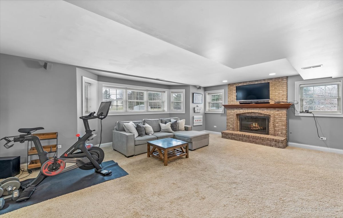 7N580 Wagontire Road St. Charles, IL 60175 - Photo 31 of 52 a living room with furniture a fireplace and a flat screen tv