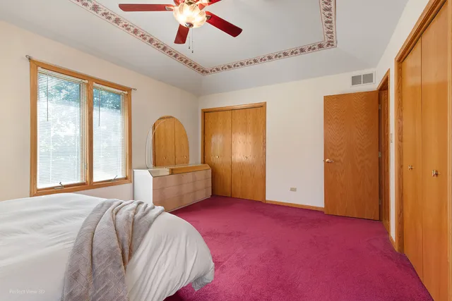 a bed room with a bed and a chandelier