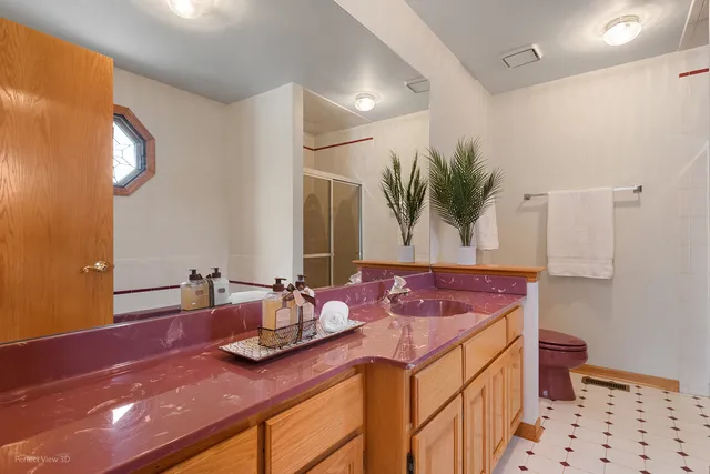 a bathroom with a granite countertop sink a mirror and vanity