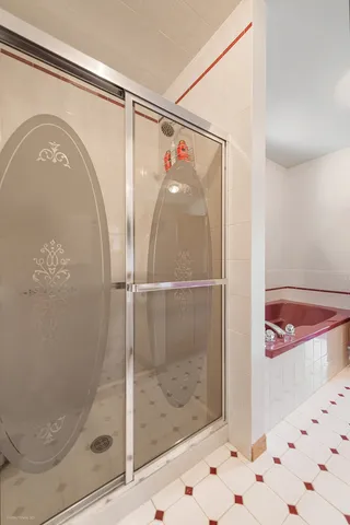 a bathroom with a glass shower door