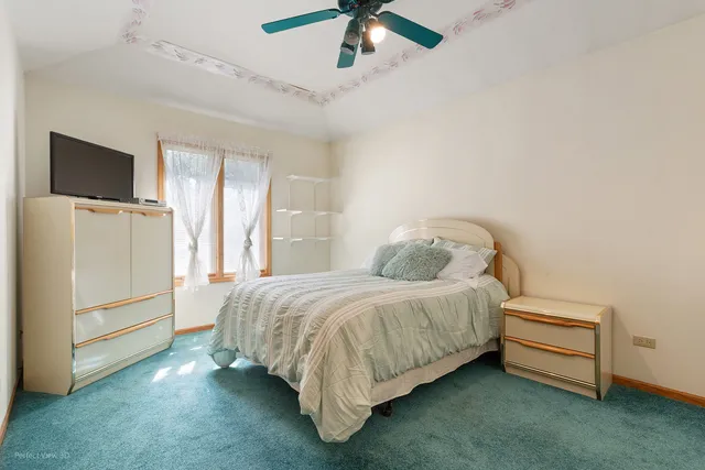 a bedroom with a bed and a flat tv screen