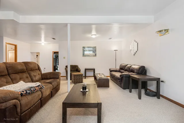 a living room with furniture a rug and a window