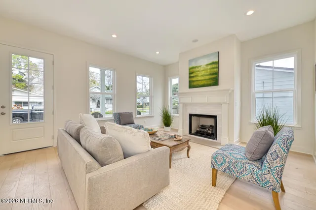 a living room with furniture and a fireplace