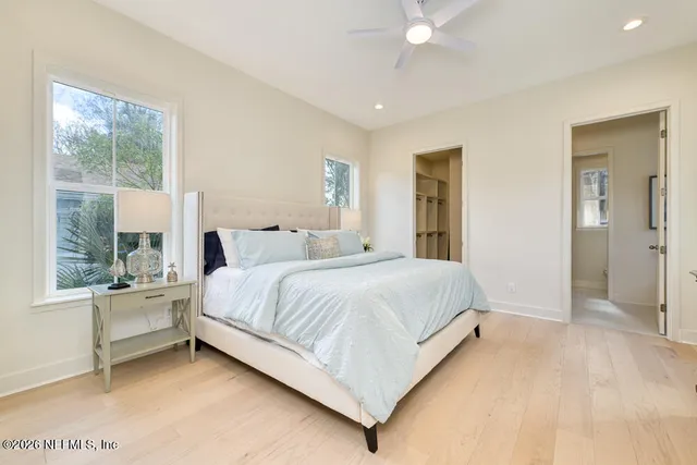 a bedroom with a large bed and a large window