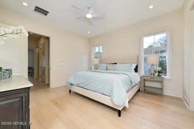 a spacious bedroom with a bed and a table