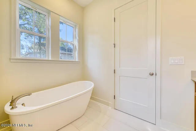 a white bath tub sitting next to a white toilet