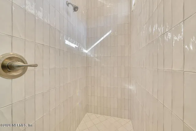 a bathroom with a shower and a window