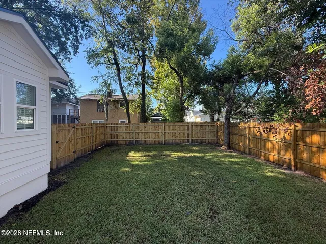 a backyard of a house with lots of green space