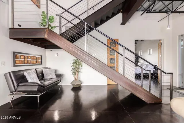 a dining room with furniture a floor to ceiling window and wooden floor
