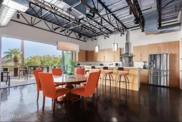 a dining room with wooden floor a glass table and chairs