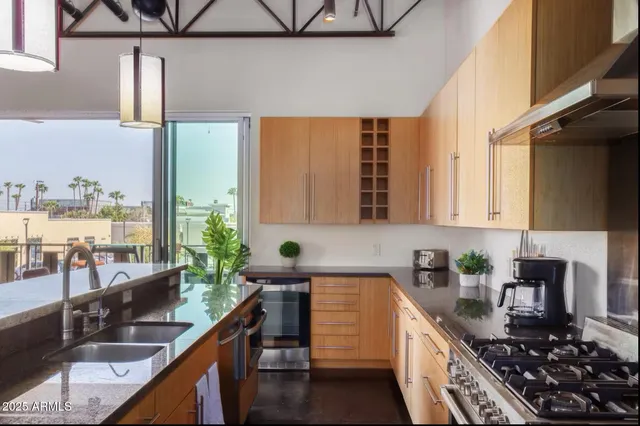 a kitchen with stainless steel appliances granite countertop a stove and a refrigerator