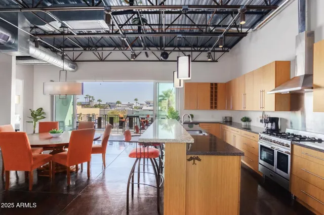 a kitchen with stainless steel appliances granite countertop a sink and cabinets