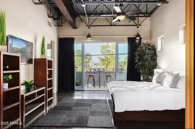 a bedroom with a bed and wooden floor