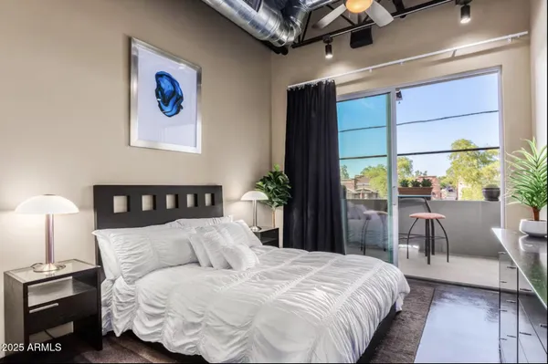 a bedroom with a bed and a potted plant