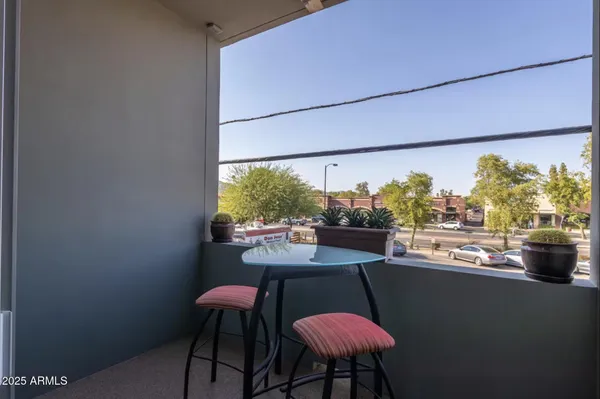 a bedroom with a bed window and table