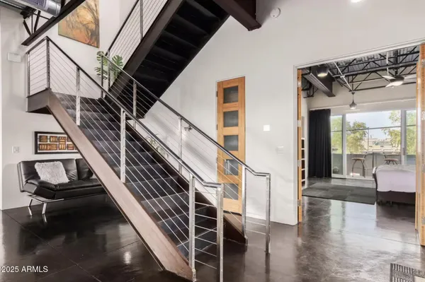a roof deck with couches and a fireplace