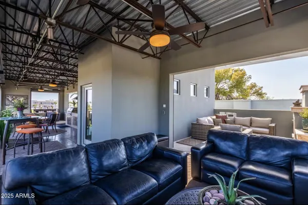 a view of a chairs and table in the balcony