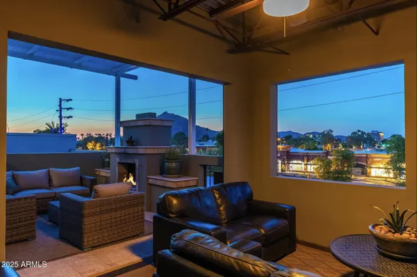 a living room with furniture and a floor to ceiling window