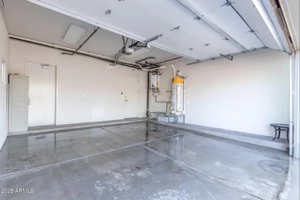 a front view of multi story residential apartment building with yard and retail shops