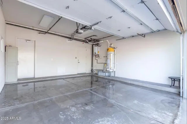 a front view of multi story residential apartment building with yard and retail shops