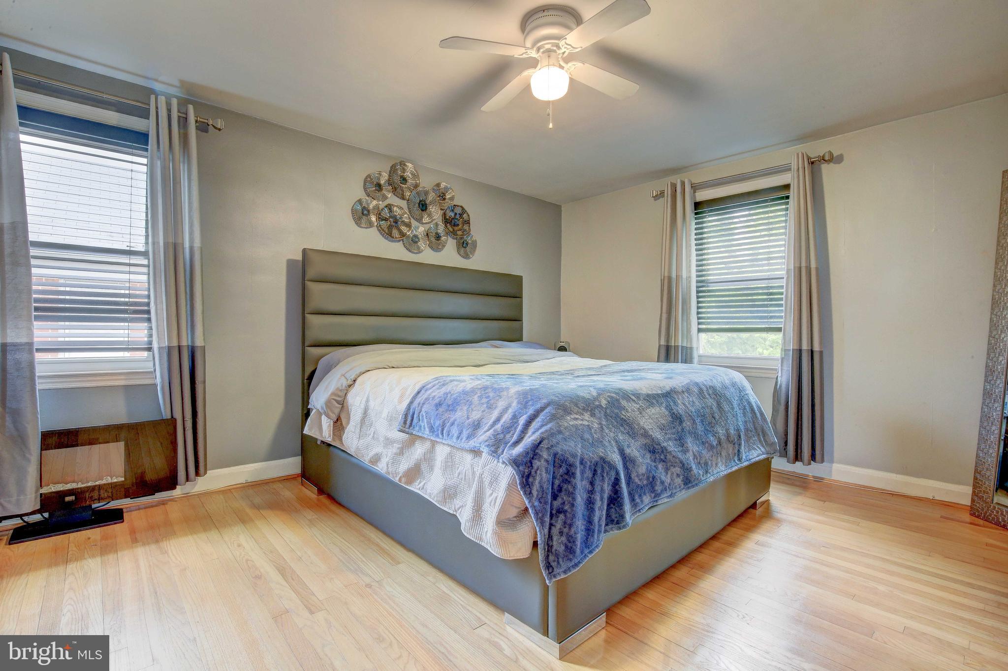 1543 Northbourne Road Baltimore, MD 21239 - Photo 14 of 20 a bed sitting in a bedroom next to a window