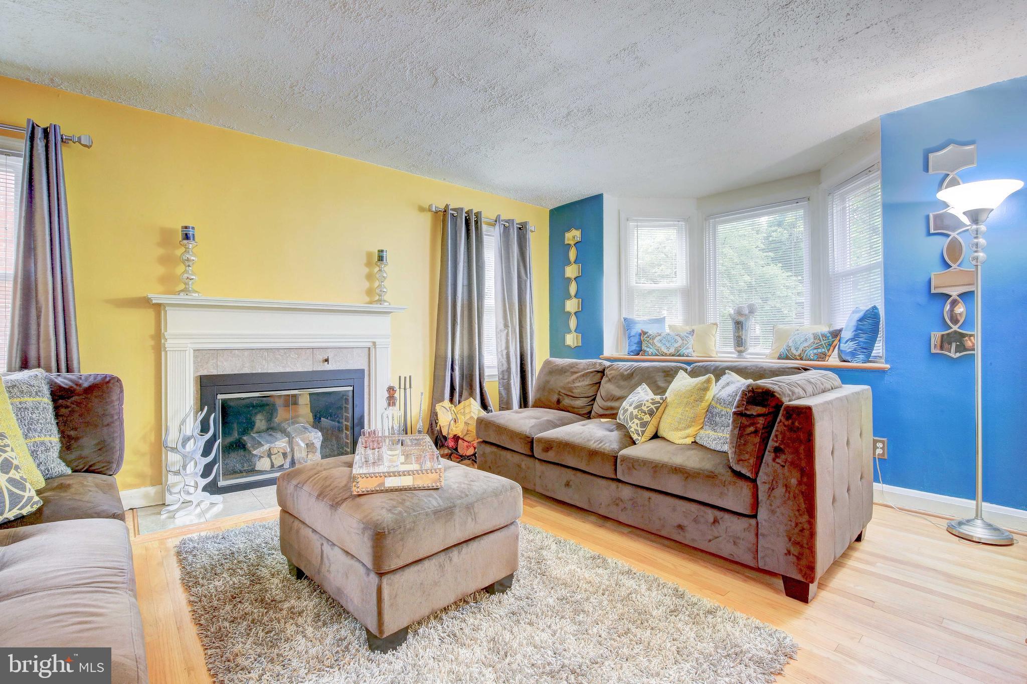 1543 Northbourne Road Baltimore, MD 21239 - Photo 5 of 20 a living room with furniture and a fireplace
