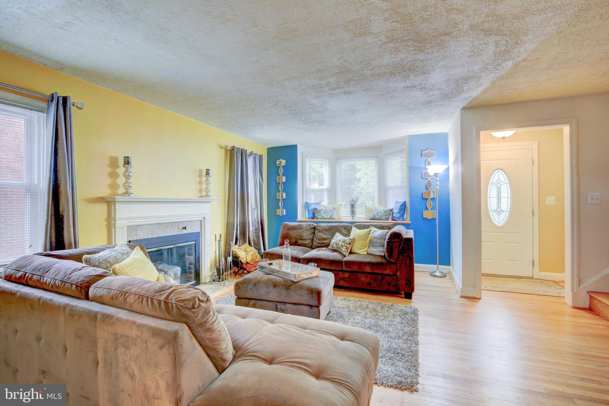 1543 Northbourne Road Baltimore, MD 21239 - Photo 6 of 20 a living room with furniture and a fireplace