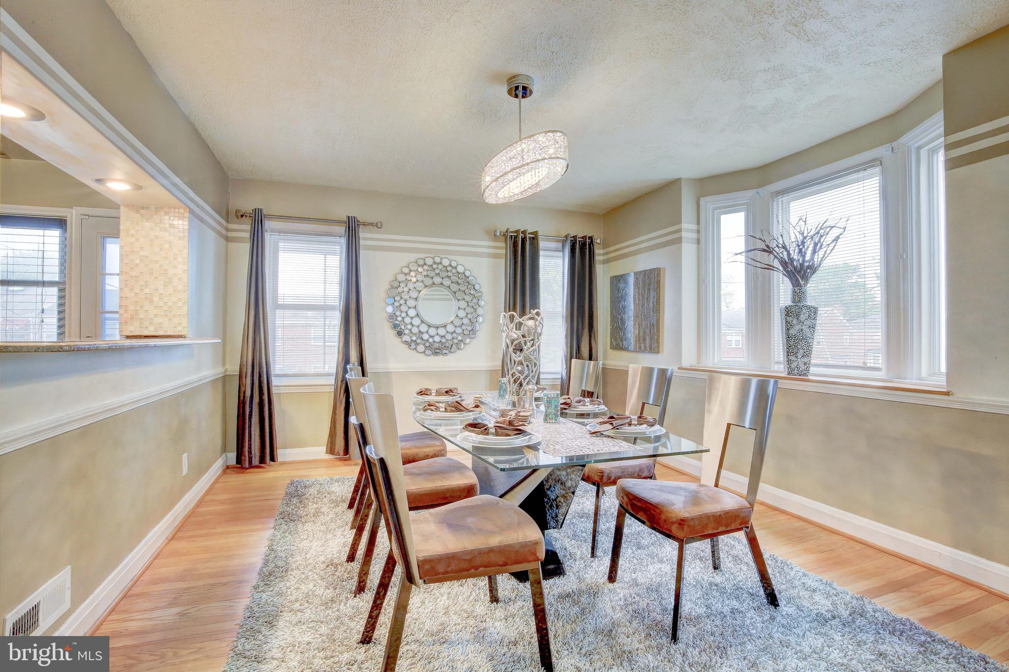 1543 Northbourne Road Baltimore, MD 21239 - Photo 7 of 20 a dining room with furniture a rug and a large window