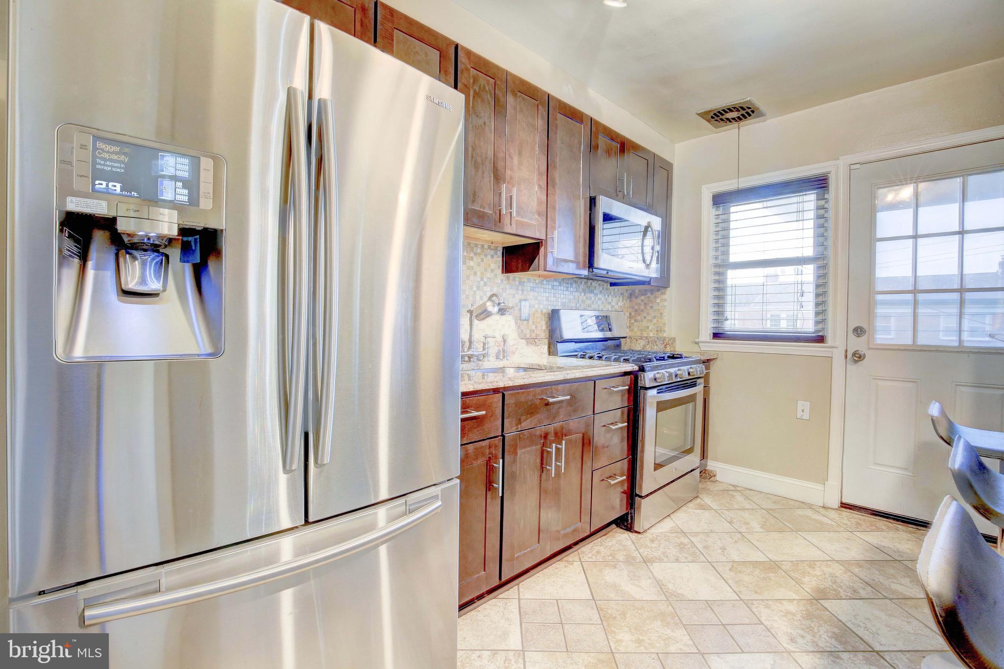 1543 Northbourne Road Baltimore, MD 21239 - Photo 10 of 20 a kitchen with stainless steel appliances granite countertop a refrigerator and a stove top oven