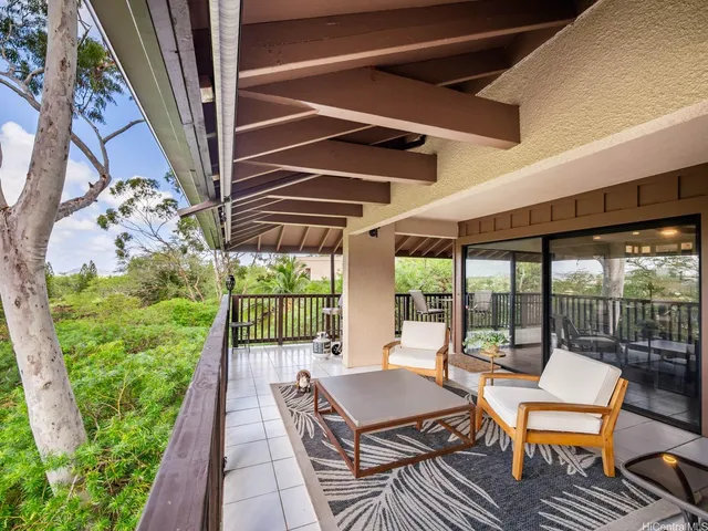 a outdoor space with patio the couches and a dining table and chairs with wooden floor