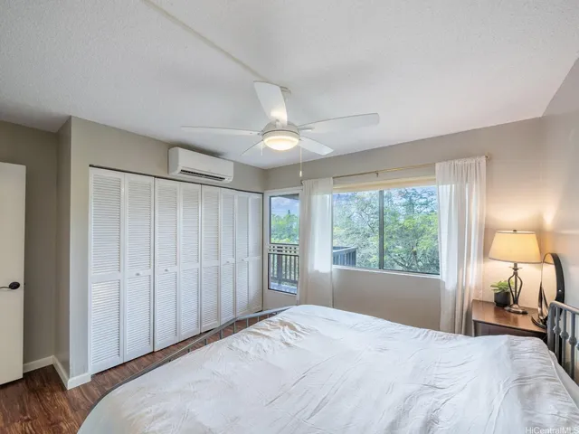 a bathroom with a granite countertop sink a toilet a mirror and shower