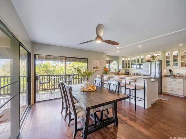 a kitchen with granite countertop kitchen island stainless steel appliances a sink stove and cabinets