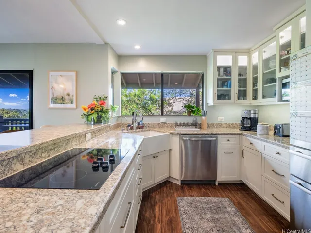 a kitchen with sink stove and refrigerator