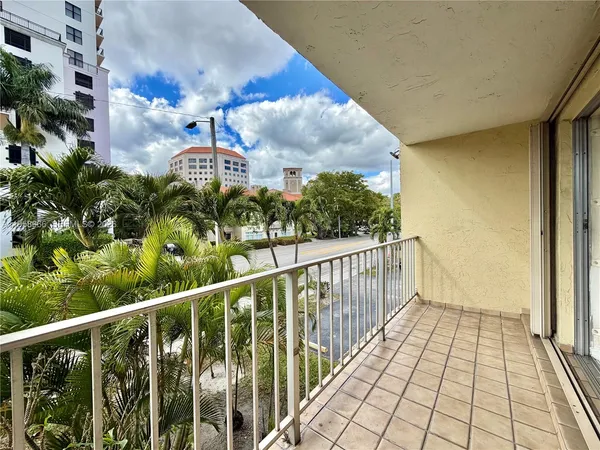 a view of a balcony with wooden floor