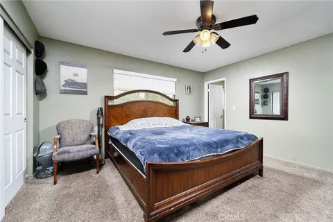 a bedroom with bed and a chandelier