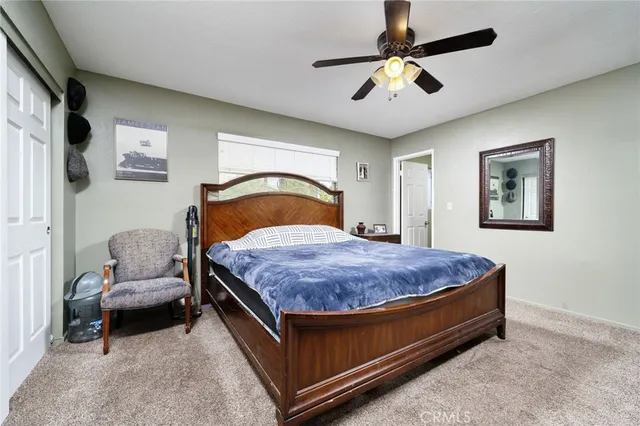 a bedroom with bed and a chandelier
