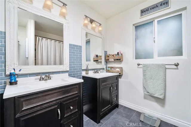 a bedroom with a bed and a flat tv screen on the dresser