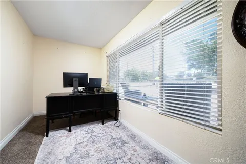 a view of a backyard with table and chairs and a tree