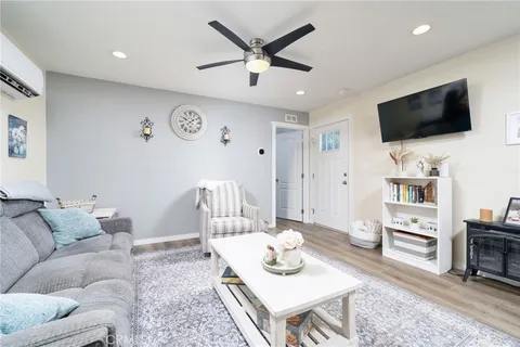 a kitchen with stainless steel appliances granite countertop a sink a refrigerator and wooden cabinets