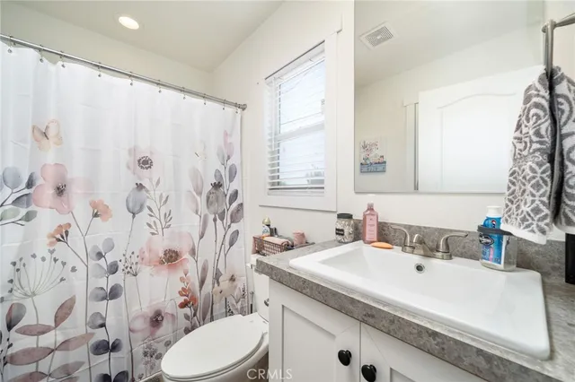 a view of a backyard with table and chairs under an umbrella