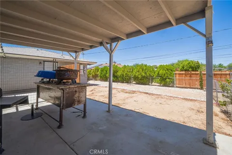 an aerial view of a house with a yard and wooden fence