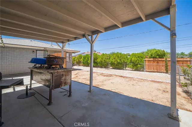 an aerial view of a house with a yard and wooden fence